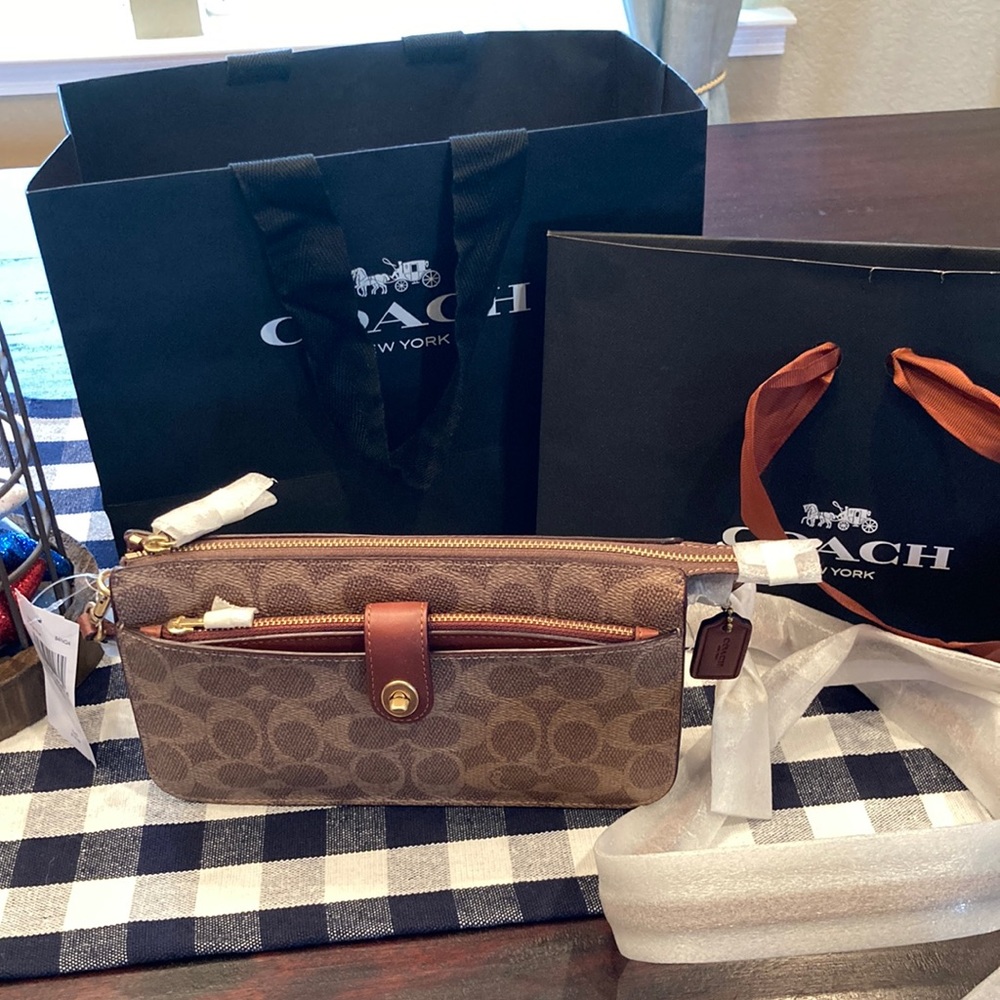 Really cute new with tags small coach purse. Could be worn as a crossbody .